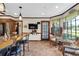 Eat-in kitchen with granite counters, stainless appliances, and adjacent sitting area with natural light at 4702 Sequoia Sw Dr, Lilburn, GA 30047