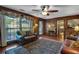 Cozy wood-paneled living room with plush seating, a ceiling fan, and a view of the outdoors at 4702 Sequoia Sw Dr, Lilburn, GA 30047