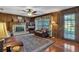 Comfortable living room with wood paneling, a fireplace, and plush seating at 4702 Sequoia Sw Dr, Lilburn, GA 30047