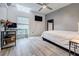 Bright bedroom with modern grey floors, a ceiling fan, and ample natural light at 5105 Davidson Ne Rd, Marietta, GA 30068