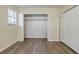 Bedroom featuring wood floors, a closet, and a window with a wardrobe at 5105 Davidson Ne Rd, Marietta, GA 30068