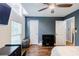 Cozy bedroom featuring hardwood floors, a ceiling fan, and shiplap accent wall at 5105 Davidson Ne Rd, Marietta, GA 30068