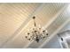 Detailed view of a chandelier hanging from a vaulted ceiling at 5105 Davidson Ne Rd, Marietta, GA 30068