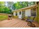 Wood deck with a grill and chairs, perfect for outdoor dining and relaxation at 5105 Davidson Ne Rd, Marietta, GA 30068