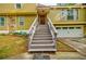 A staircase leads to the front door of a home with a two-car garage and stone accents at 5105 Davidson Ne Rd, Marietta, GA 30068