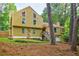 Charming two-story home with yellow siding, stone accents, and a well-maintained front yard at 5105 Davidson Ne Rd, Marietta, GA 30068