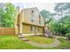 Two-story home with yellow siding, stone accents, and a well-maintained lawn at 5105 Davidson Ne Rd, Marietta, GA 30068