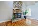 Elegant stone fireplace complemented by hardwood floors and a bay window at 5105 Davidson Ne Rd, Marietta, GA 30068