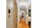 Inviting hallway featuring hardwood floors and a view of the stone fireplace, creating a warm, welcoming atmosphere at 5105 Davidson Ne Rd, Marietta, GA 30068