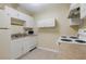 A functional kitchen with white cabinets, essential appliances, and neutral countertops at 5105 Davidson Ne Rd, Marietta, GA 30068