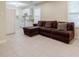 This living room offers tiled floors and a cozy brown sofa near the bright kitchen area at 5105 Davidson Ne Rd, Marietta, GA 30068