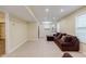 Open concept living room with tile flooring, a brown couch, and a view into the kitchen at 5105 Davidson Ne Rd, Marietta, GA 30068