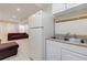 Basement living area includes a kitchenette with sink, white refrigerator, and comfy seating at 5105 Davidson Ne Rd, Marietta, GA 30068
