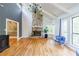 Spacious living room with a stone fireplace, hardwood floors, and vaulted ceilings at 5105 Davidson Ne Rd, Marietta, GA 30068