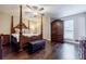 Spacious main bedroom featuring a four-poster bed, and abundant storage at 5105 Davidson Ne Rd, Marietta, GA 30068