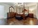Elegant main bedroom featuring a four-poster bed, dark wood floors, and a ceiling fan at 5105 Davidson Ne Rd, Marietta, GA 30068