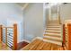 Light and bright entryway featuring wooden staircase and modern railing at 5105 Davidson Ne Rd, Marietta, GA 30068