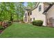 Expansive backyard with well-maintained lawn, mature trees, privacy fence, and a glimpse of the in-ground pool at 1824 Mallard Lake Dr, Marietta, GA 30068