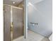 Bathroom featuring a shower with glass doors, accessible grab bar, and tile flooring at 1824 Mallard Lake Dr, Marietta, GA 30068