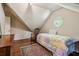Sloped ceiling bedroom with wood floors, area rug and round window at 1824 Mallard Lake Dr, Marietta, GA 30068