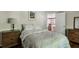 Comfortable bedroom features a bed with soft blankets, art and dressers at 1824 Mallard Lake Dr, Marietta, GA 30068