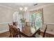 Traditional dining room featuring hardwood floors, large window, and chandelier lighting at 1824 Mallard Lake Dr, Marietta, GA 30068