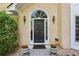 Inviting front entrance features a decorative door, stylish lighting, and potted plants at 1824 Mallard Lake Dr, Marietta, GA 30068