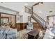 Open living room flows to a stairway and has detailed trim, hardwood floors, and comfortable seating at 1824 Mallard Lake Dr, Marietta, GA 30068