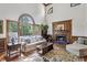 Bright living room boasts a fireplace, large windows, high ceilings, and hardwood floors at 1824 Mallard Lake Dr, Marietta, GA 30068