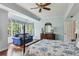 Bedroom with hardwood floors, ceiling fan, and a traditional-style four-poster bed near a window at 1824 Mallard Lake Dr, Marietta, GA 30068