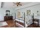 Bedroom with hardwood floors, ceiling fan, and a traditional-style four-poster bed at 1824 Mallard Lake Dr, Marietta, GA 30068
