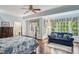 Bedroom with hardwood floors, ceiling fan, and a traditional-style four-poster bed near a window at 1824 Mallard Lake Dr, Marietta, GA 30068