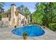 Backyard features a sparkling pool, lush landscaping, and lounge chairs for relaxation at 1824 Mallard Lake Dr, Marietta, GA 30068