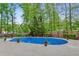 Inviting outdoor pool surrounded by lush greenery and a wooden fence at 1824 Mallard Lake Dr, Marietta, GA 30068