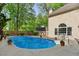 Private backyard pool with mature trees and lush greenery behind a wooden fence at 1824 Mallard Lake Dr, Marietta, GA 30068