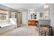 Bright bathroom with double vanity, a shower, and a large garden tub by the window at 233 Hampton Station Blvd, Canton, GA 30115