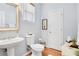 Charming powder room with pedestal sink, window, and stylish decor at 233 Hampton Station Blvd, Canton, GA 30115