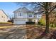 Charming two-story home with a well-manicured front yard, two-car garage, and attractive curb appeal at 233 Hampton Station Blvd, Canton, GA 30115