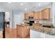 Well-equipped kitchen featuring granite countertops, a center island, and modern appliances at 233 Hampton Station Blvd, Canton, GA 30115