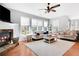 Sun-filled living room featuring a fireplace, hardwood floors and comfortable seating at 233 Hampton Station Blvd, Canton, GA 30115