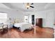 Spacious main bedroom featuring hardwood floors, a walk-in closet, and ample lighting at 233 Hampton Station Blvd, Canton, GA 30115