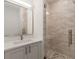 A modern bathroom with glass shower, quartz countertop vanity, and decorative tile at 1237 Memorial Se Dr # 402, Atlanta, GA 30316