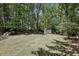 The large backyard is private and wooded with storage shed at 1390 Barclay Dr, Lawrenceville, GA 30043
