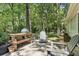 Enjoy the serene wooded views from the backyard patio with outdoor seating at 1390 Barclay Dr, Lawrenceville, GA 30043