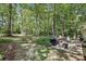 Enjoy the wooded backyard with a patio, grill, and outdoor seating for relaxing and entertaining at 1390 Barclay Dr, Lawrenceville, GA 30043