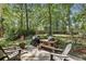 Relax on the backyard patio, complete with grill and outdoor seating, overlooking the serene woods at 1390 Barclay Dr, Lawrenceville, GA 30043