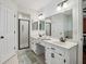 Bright bathroom with dual sinks, white cabinets, large mirror, and a glass door shower at 1390 Barclay Dr, Lawrenceville, GA 30043