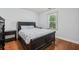 Cozy bedroom with hardwood floors, neutral walls, and natural light from the window at 1390 Barclay Dr, Lawrenceville, GA 30043