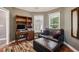 Comfortable bedroom or office space with plush seating, wooden floors, and a large built in bookcase at 1390 Barclay Dr, Lawrenceville, GA 30043