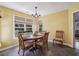 Charming dining area with modern lighting, tile floors, and large windows overlooking the backyard at 1390 Barclay Dr, Lawrenceville, GA 30043